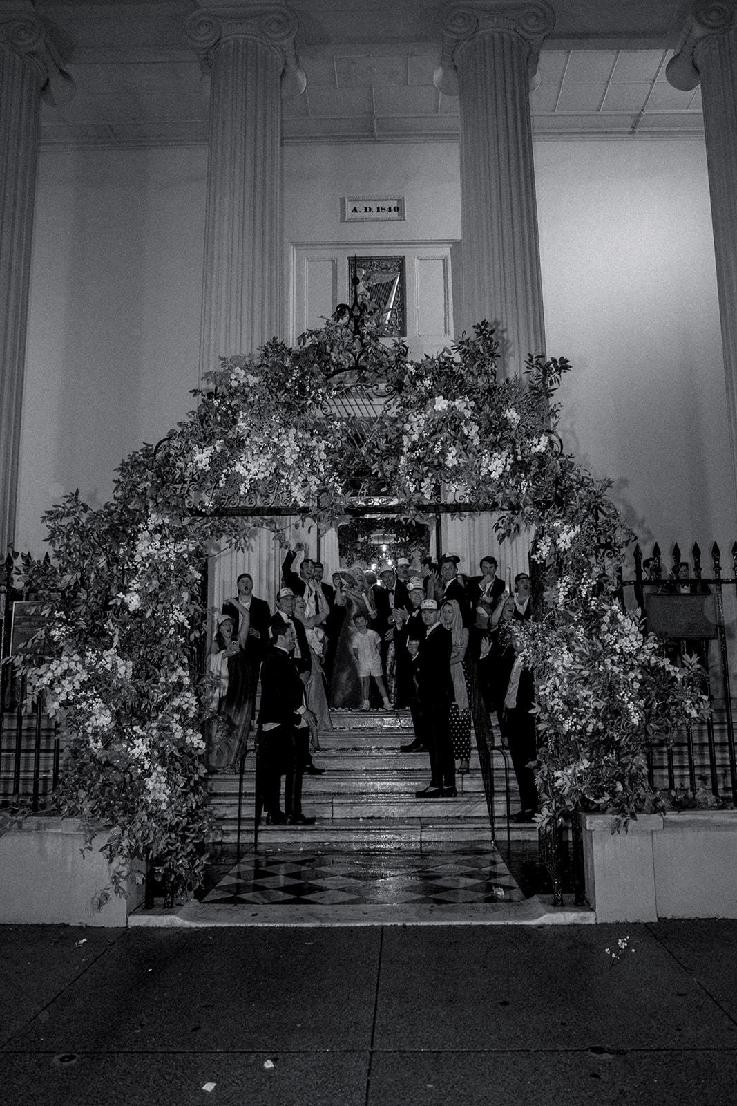 Wedding guests wave to bride and groom as they ride away 