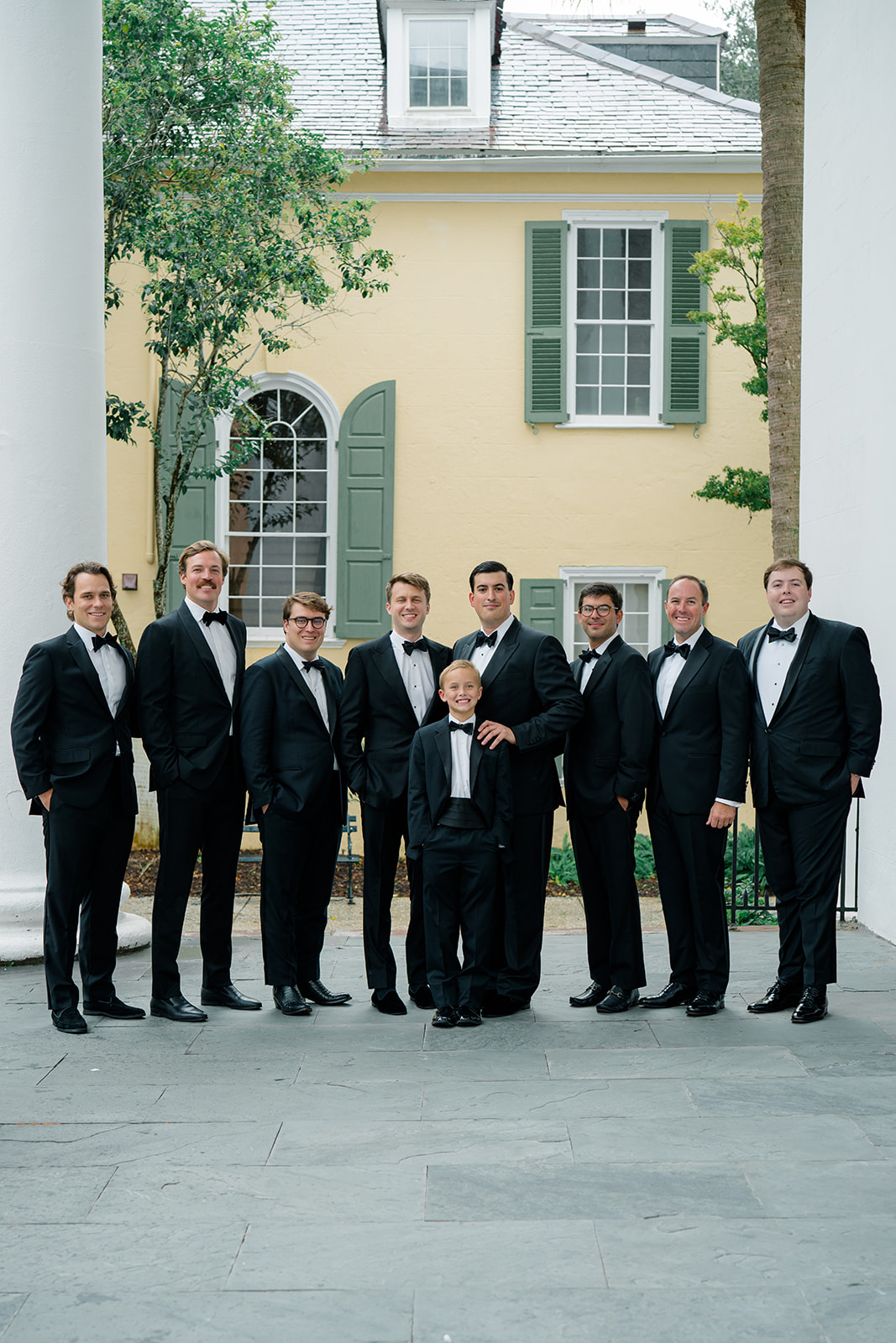 Groom and groomsmen in front of first baptist church in downtown Charleston. 