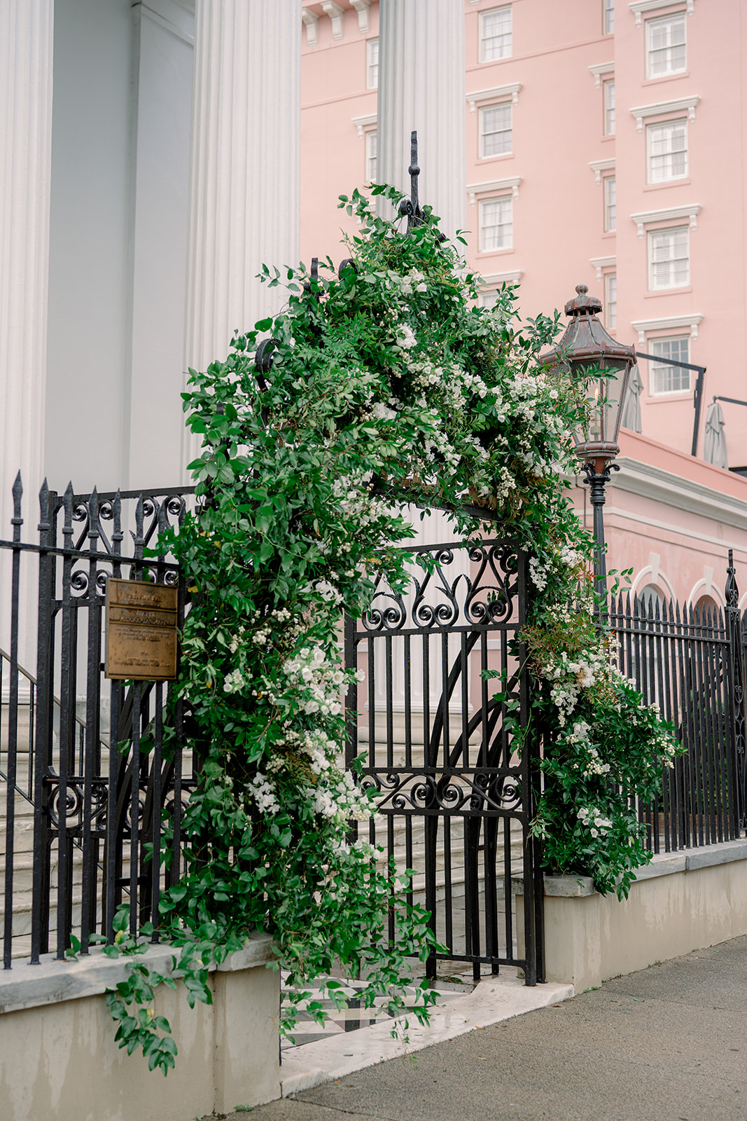 Front gate at Hibernian Hall decorated for winter wedding. white and green flowers. 