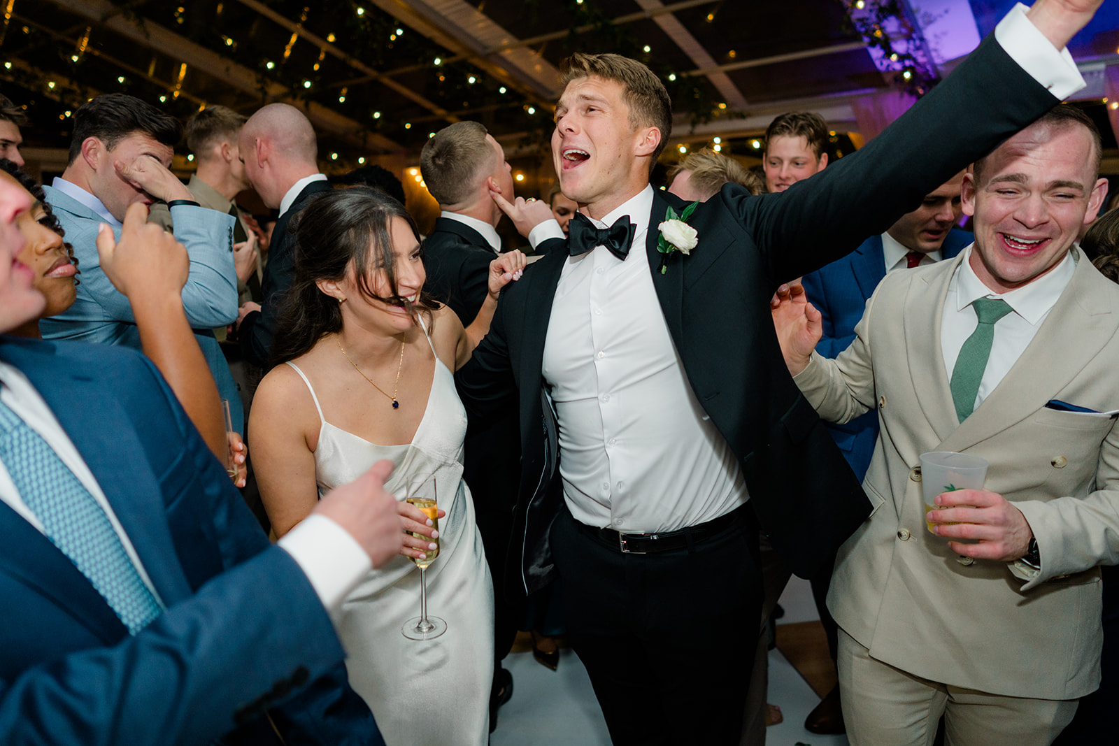 Groom singing along with the song with bride laughing during Charleston wedding reception. 