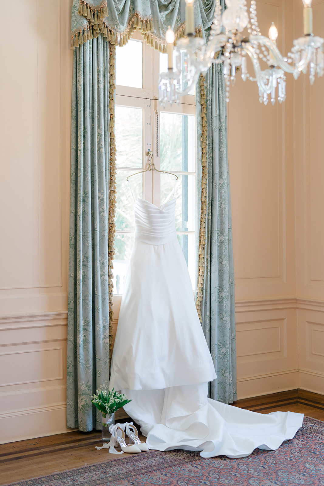 Wedding dress hanging in the pink room at Lowndes Grove. 