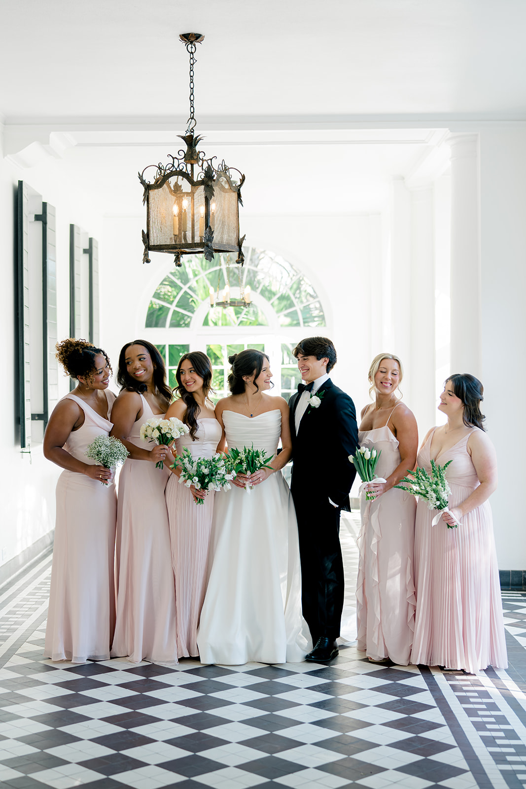 Bride's party. Bride included her brother in her wedding party with bridesmaids. Bridesmaids in pink dresses. 