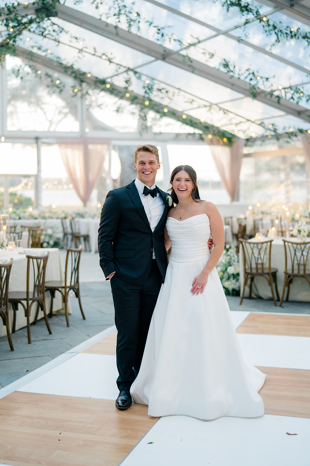 Bride and groom portrait in wedding reception tent at Lowndes Grove. 