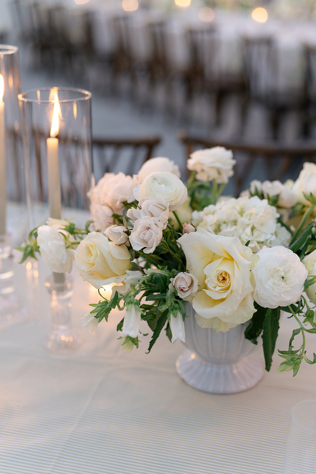 White wedding flowers with candle. Reception table top set up at Charleston wedding. 