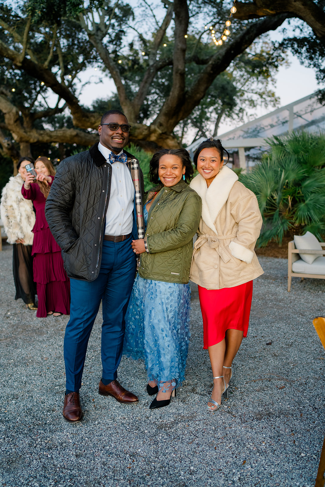Waterfront cocktail hour at Lowndes Grove. Wedding guests stop for a photo on the oyster tabby. 