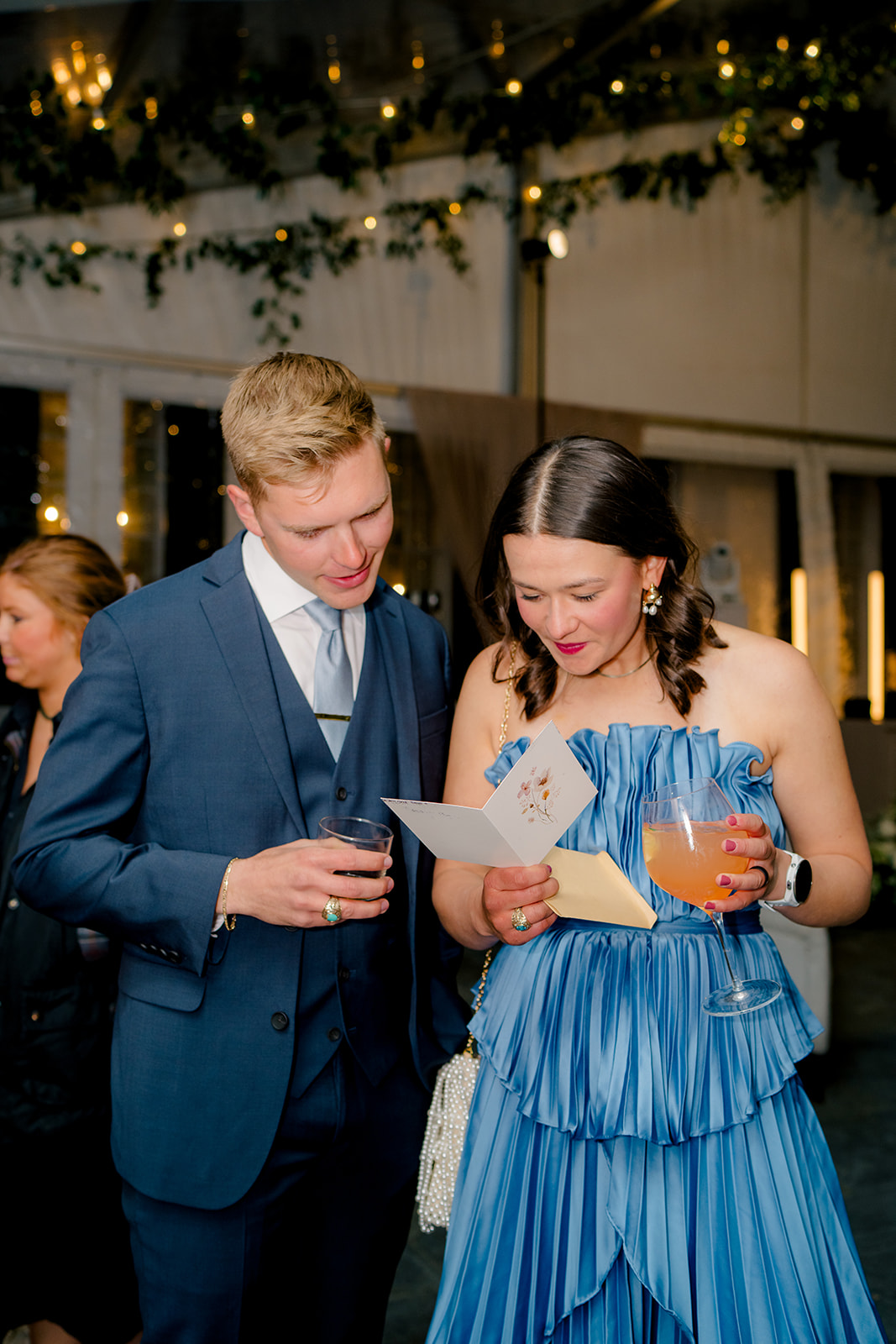Wedding guests read their letter from bride and groom at Lowndes Grove wedding reception. 