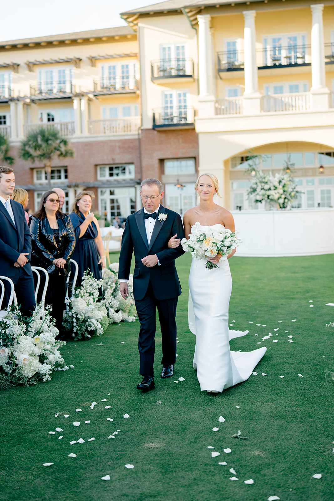 Sanctuary at Kiawah outdoor wedding ceremony. Bride walks up the aisle with her dad. Bride with blonde hair. 