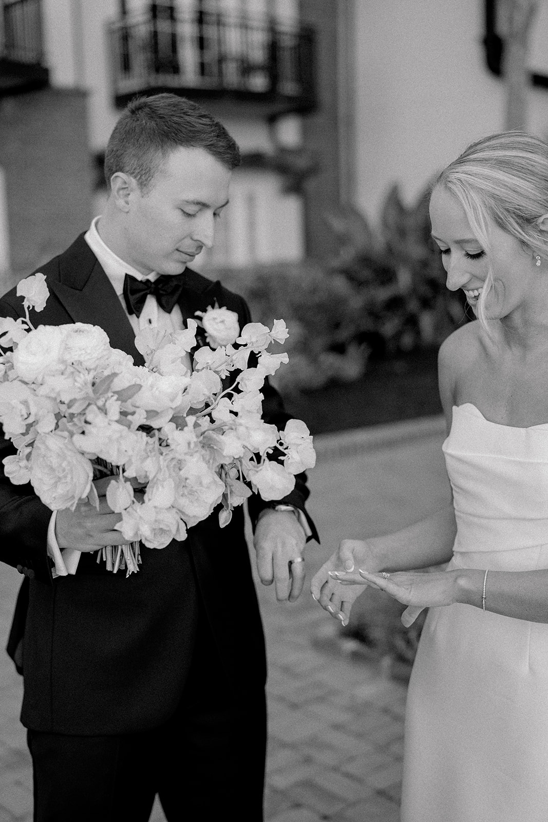 Bride and groom check out their new rings after wedding ceremony. 