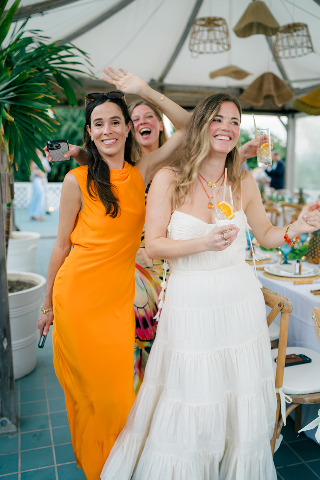 Candid moment of bride walking by with her friends. 