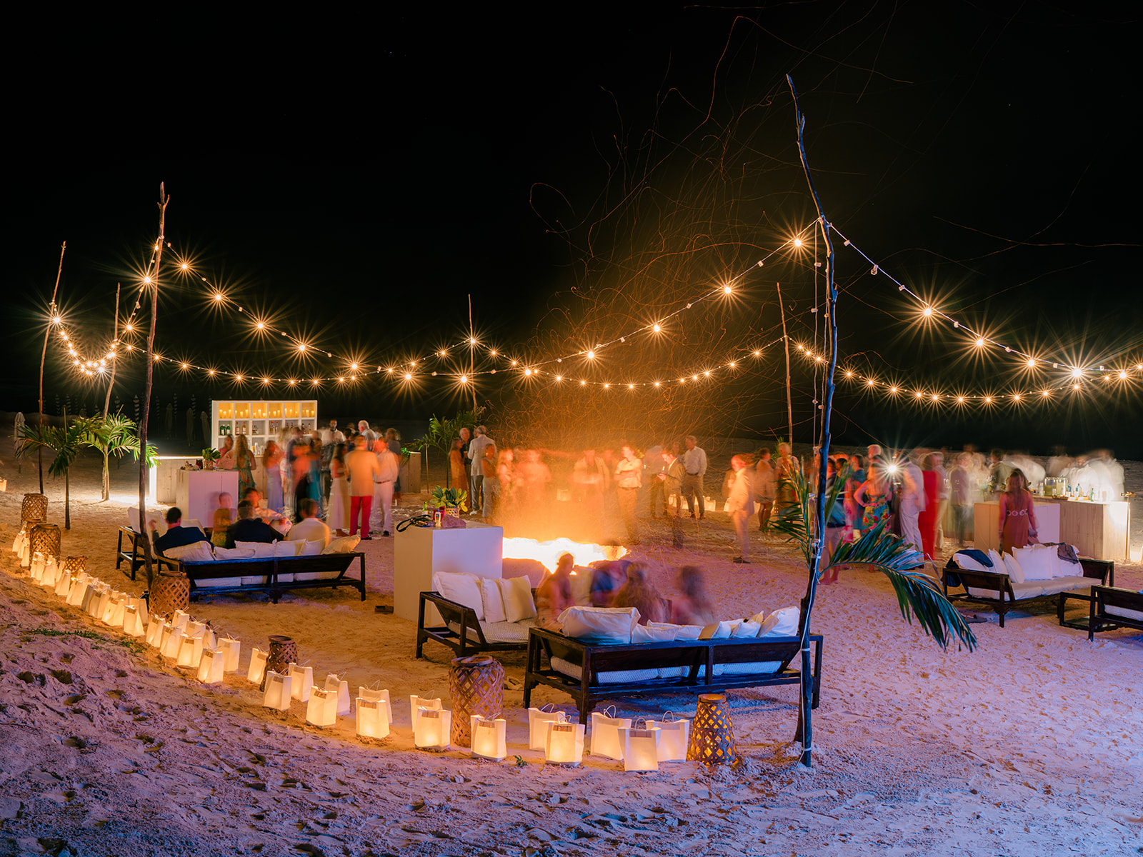 Fire pit beach front wedding welcome party under the stars. 