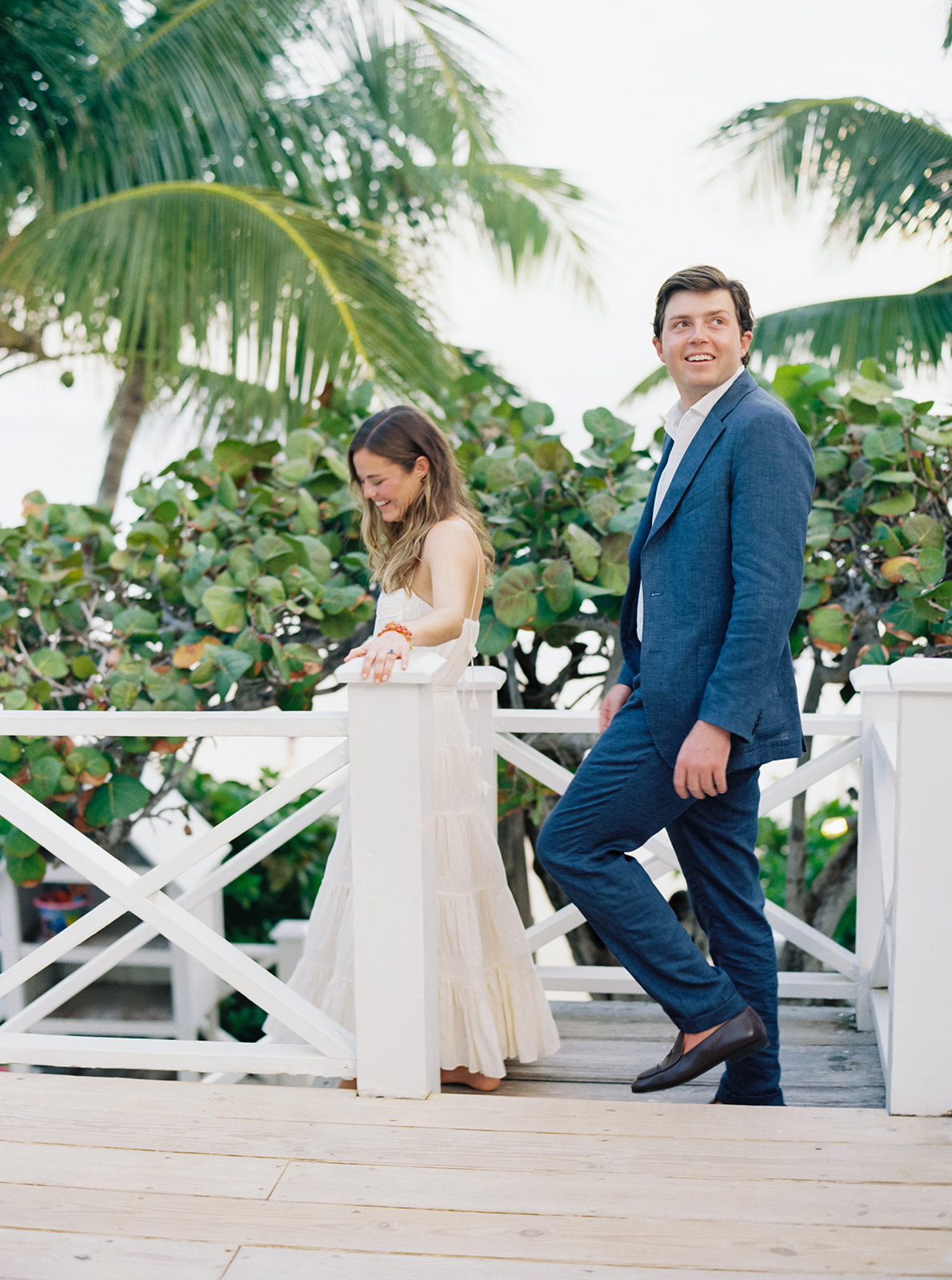 Candid moment of bride and groom walking down the steps to the beach at harbour island. 