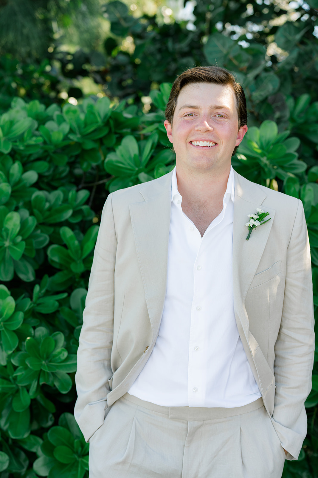 Bahamas winter wedding. Portrait of the groom in tan suit and white shirt with no tie. 