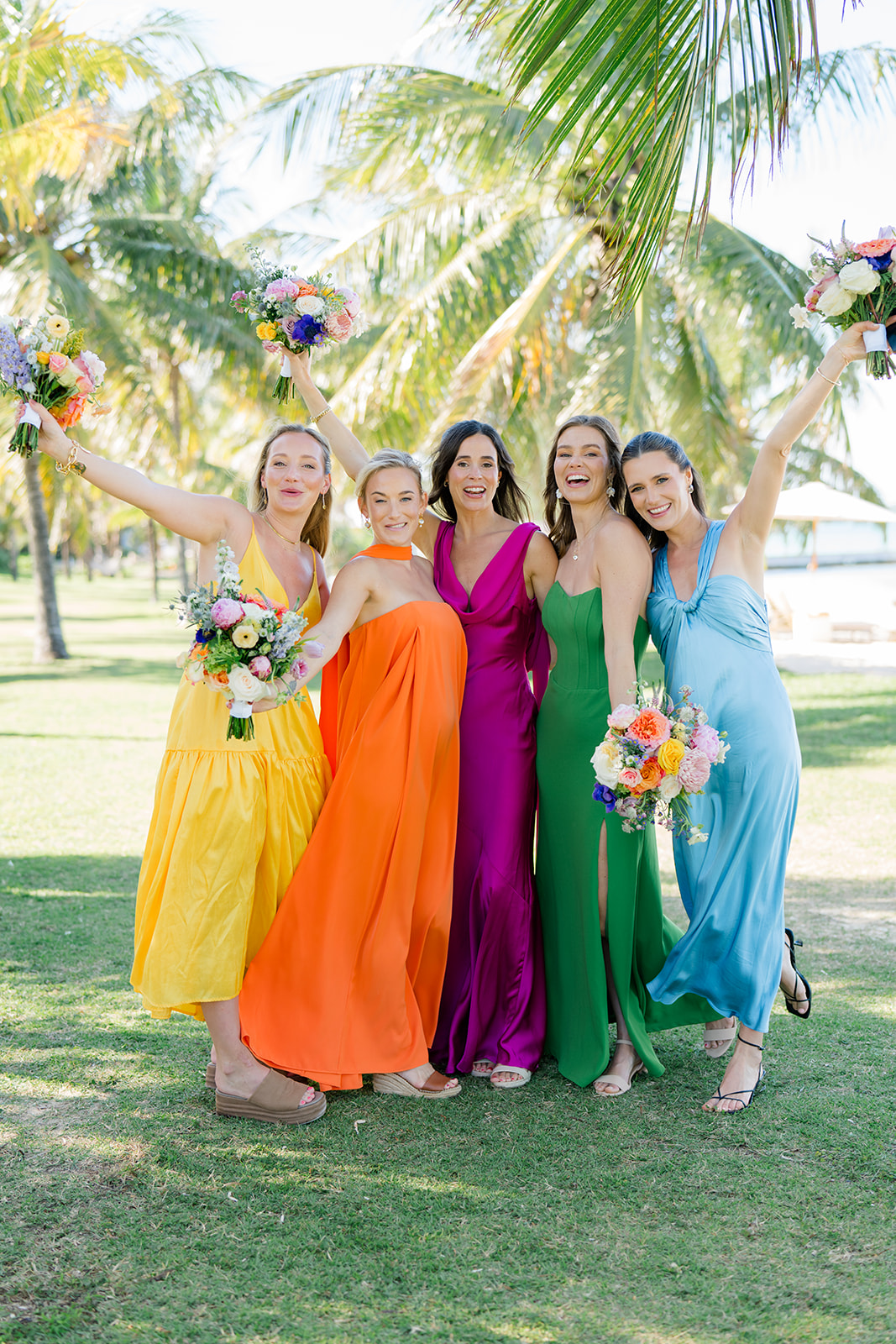Bridesmaids celebrate with their flowers. 