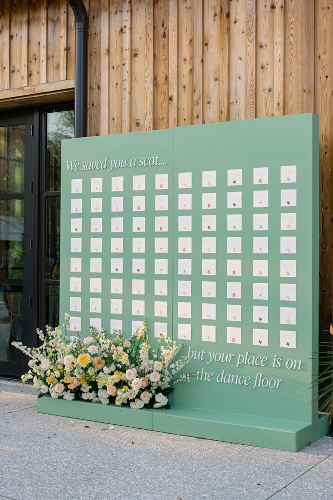 custom green seating chart with flowers. 