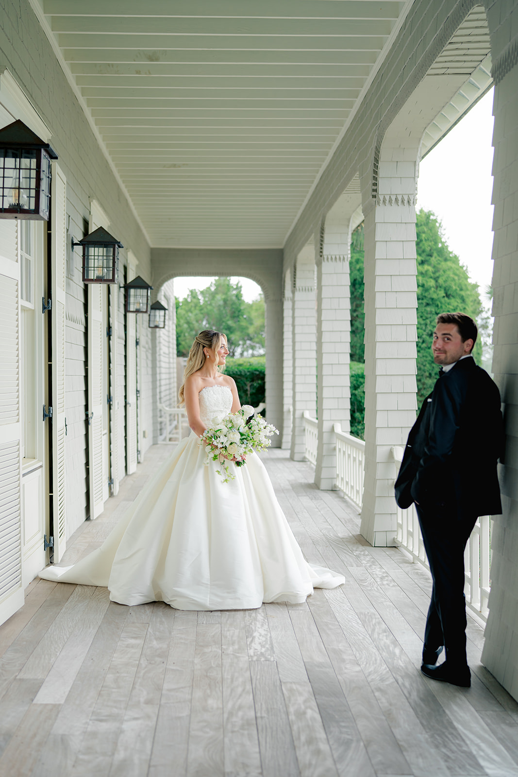 Candid of groom in the shot during brides portrait.