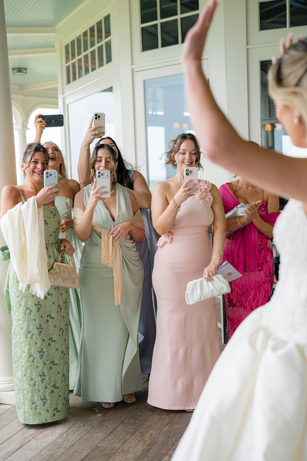 Brides friends see her in her wedding dress.