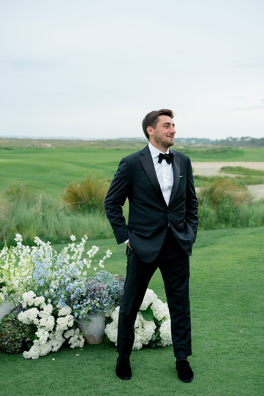 Groom smiling at wedding ceremony.