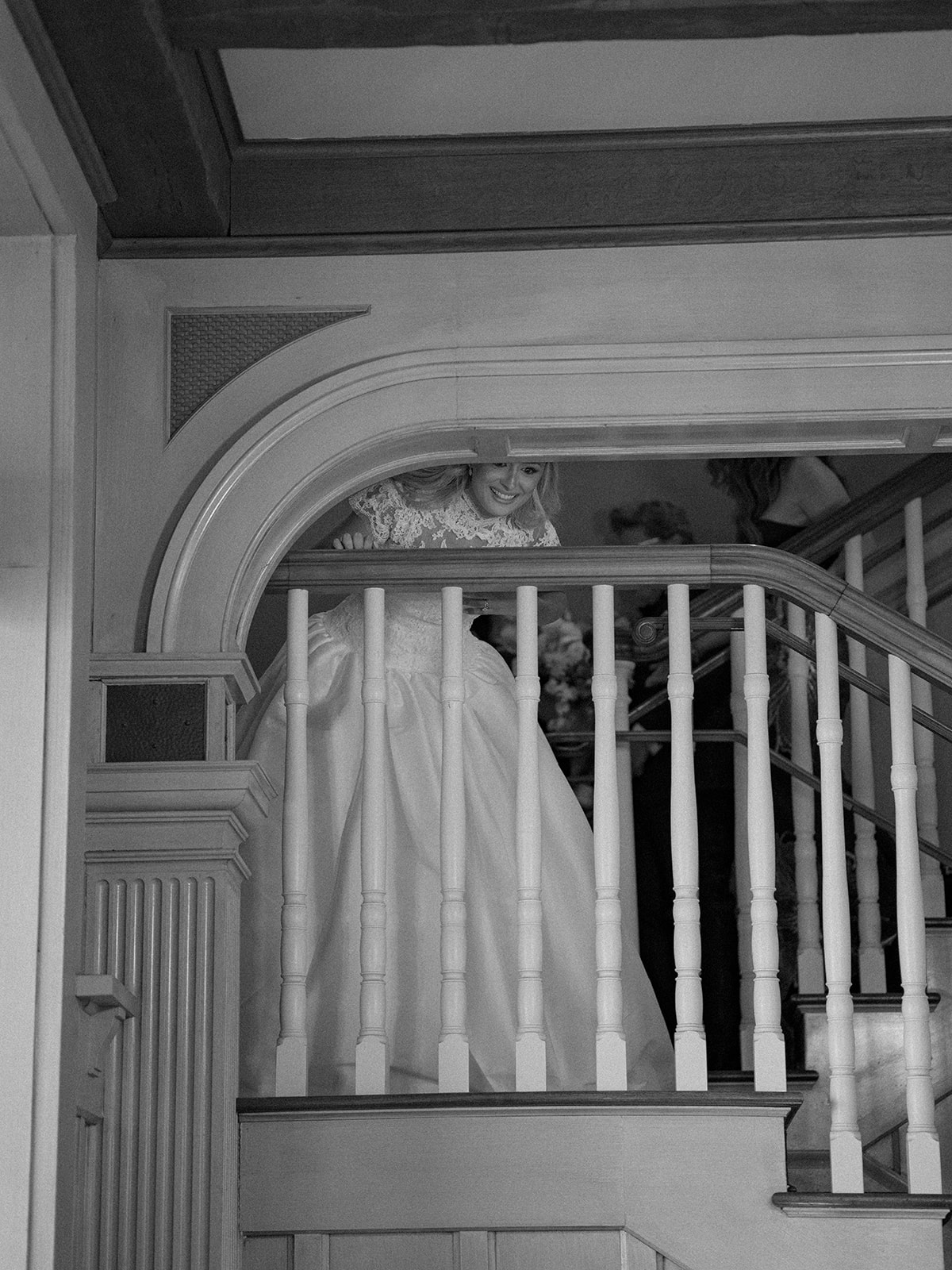 Bride peeks down the stairs to her grand parents in the clubhouse at the ocean course. 