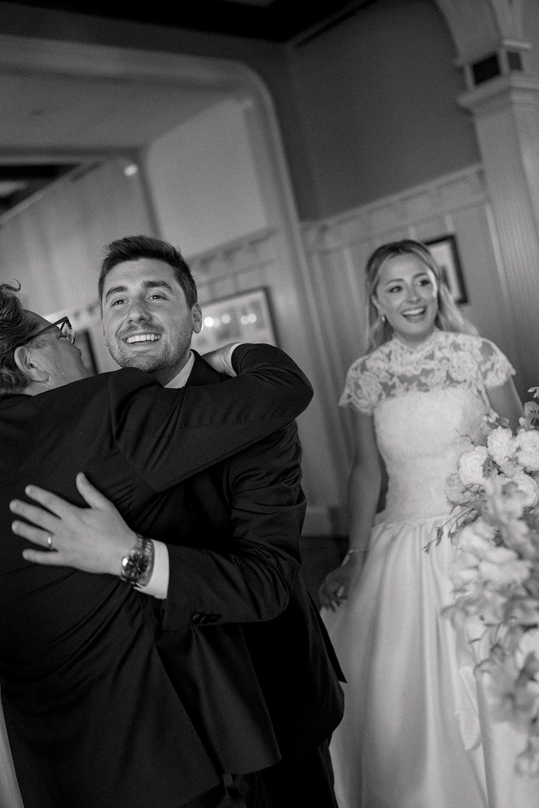 Groom hugs father of the bride