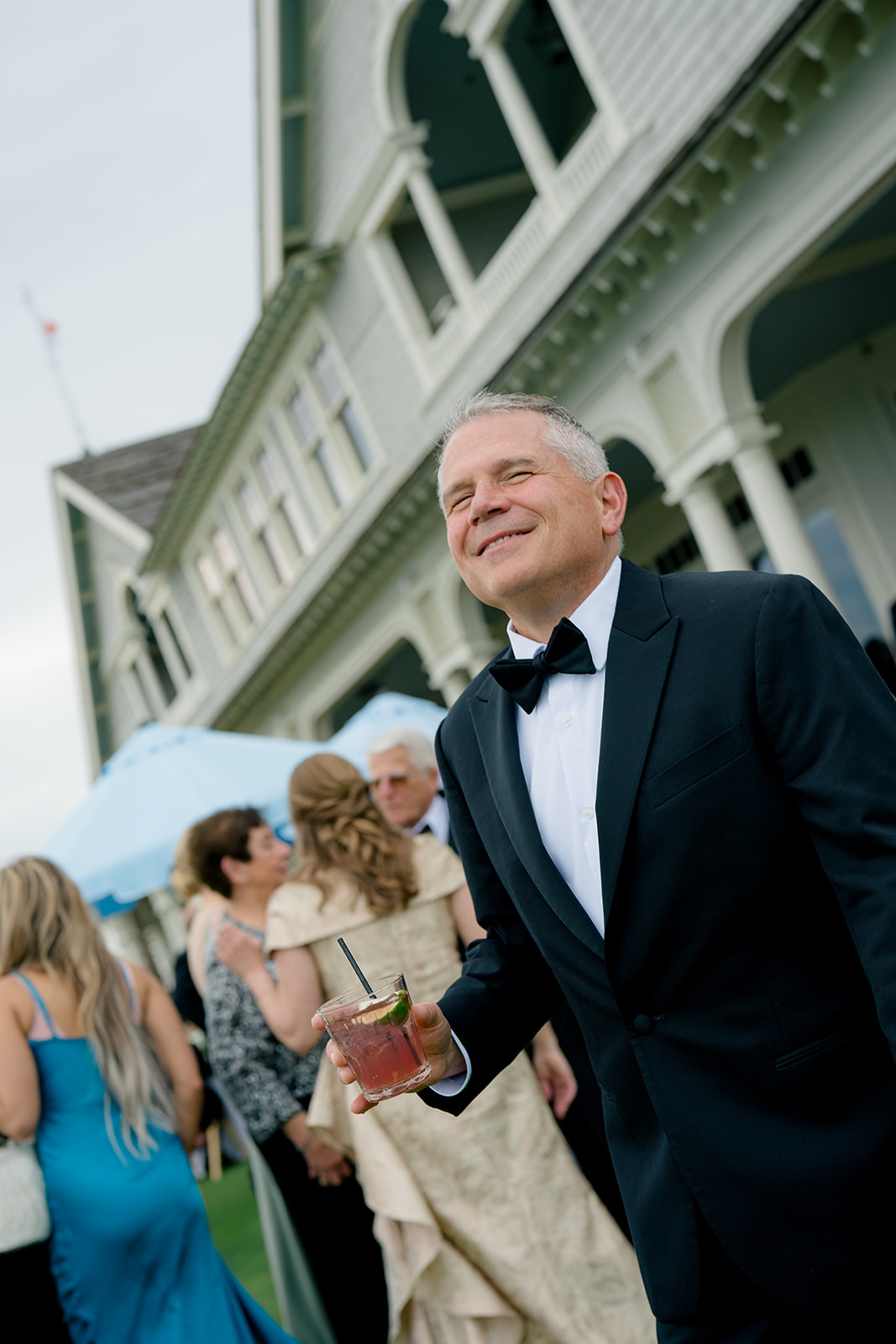 Father of the groom with a cocktail. Ocean course cocktail hour.