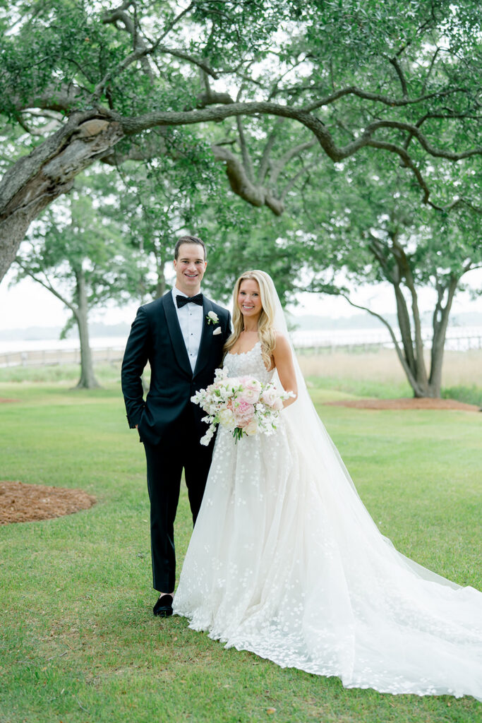 Bride and groom portrait on the lawn. Riverfront wedding in downtown Charleston. 