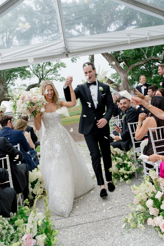 Bride and groom exit through flower petals. 