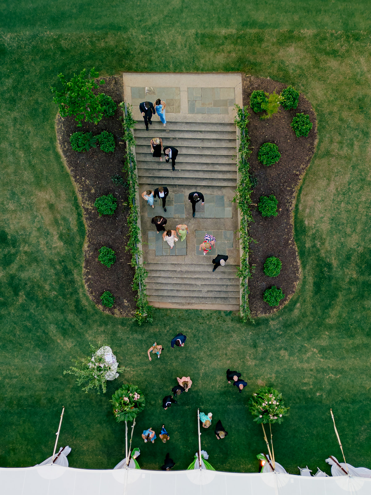 View from above of wedding guests walking down the steps.
