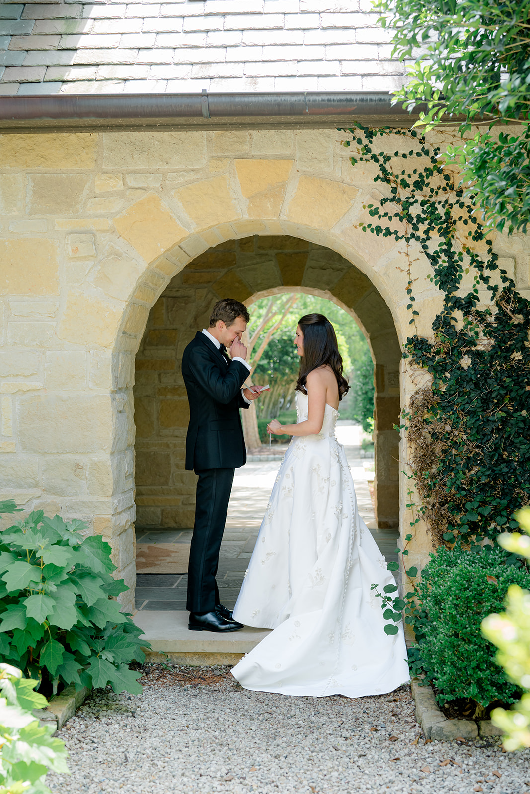 Groom wipes away tears during private vow reading.
