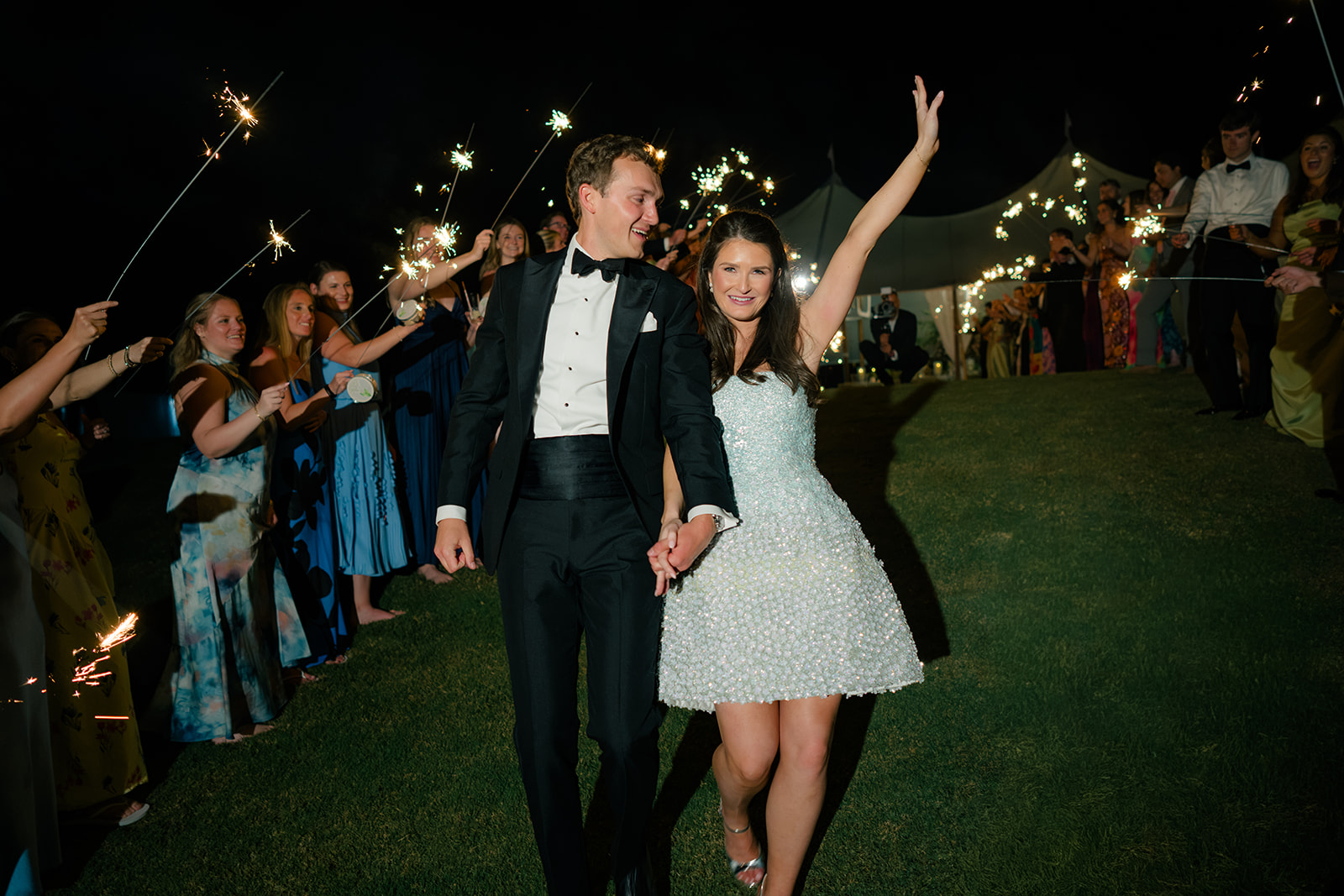 Bride celebrates during sparkler exit. 