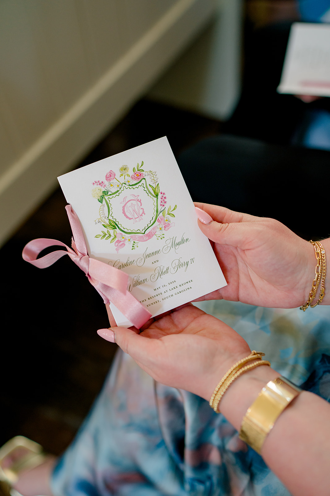 Custom pink and green wedding ceremony program with pink ribbon