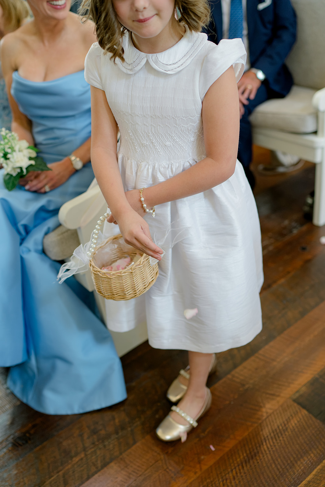 flower girl spreading flower petals.