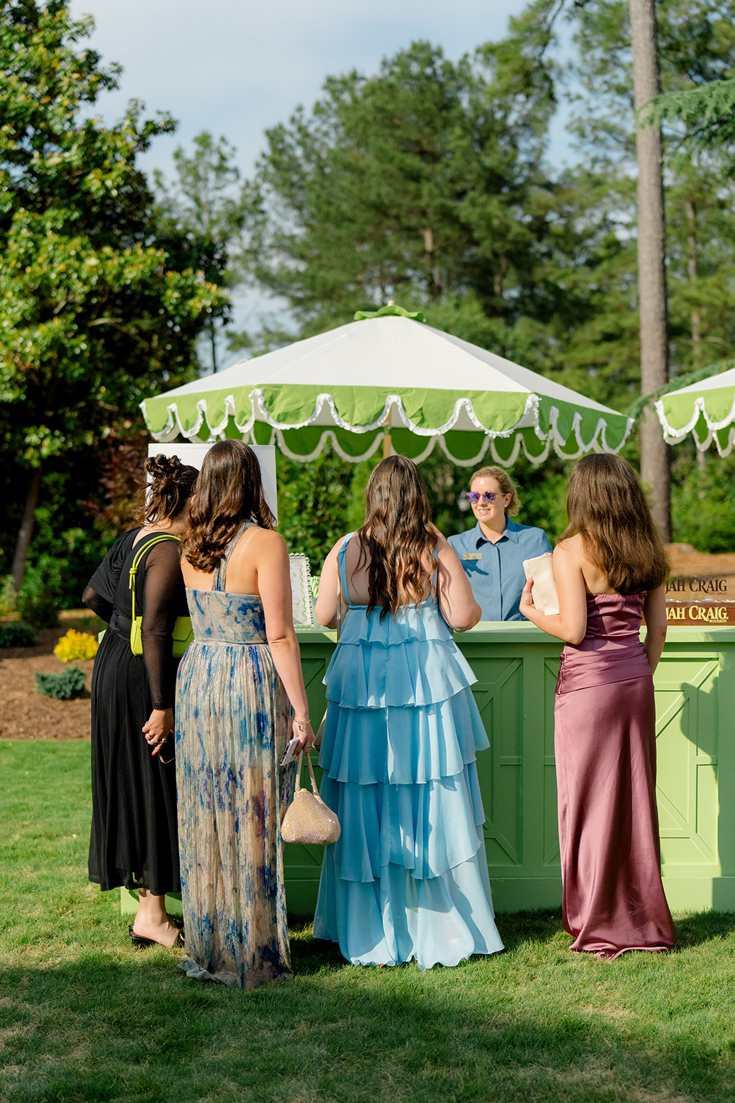 Wedding guests at green bar during cocktail hour. 